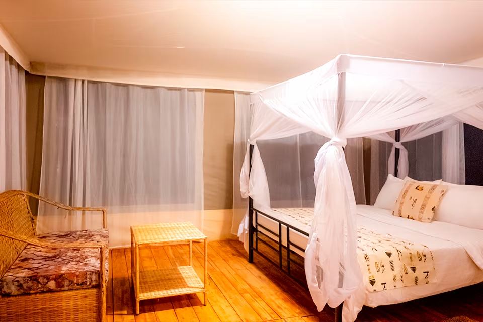 Double Tented Room: the bed, canvas walls and the view from the veranda
