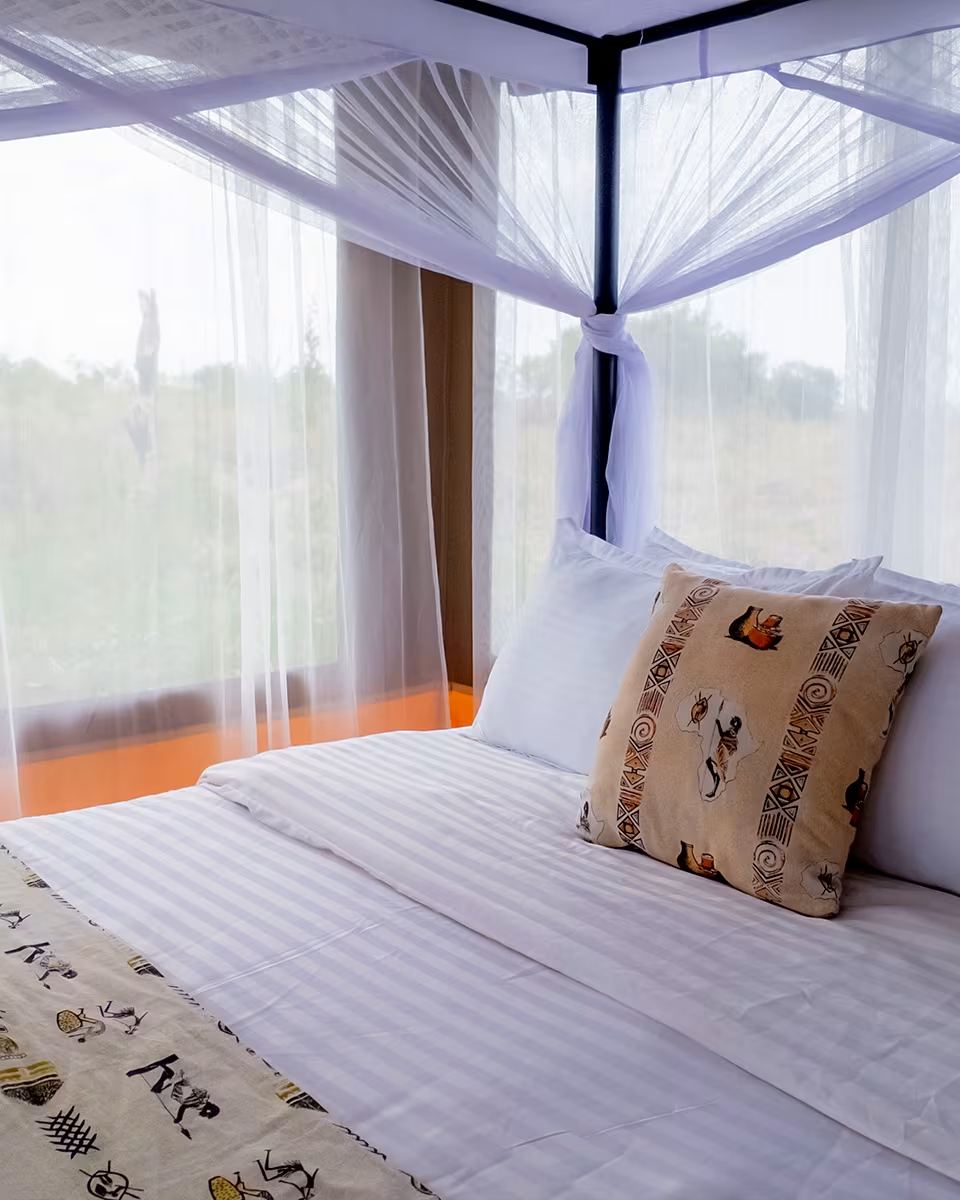 The bed made up under a mosquito net