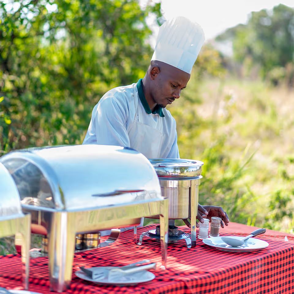 The chef laying out the breakfast spread